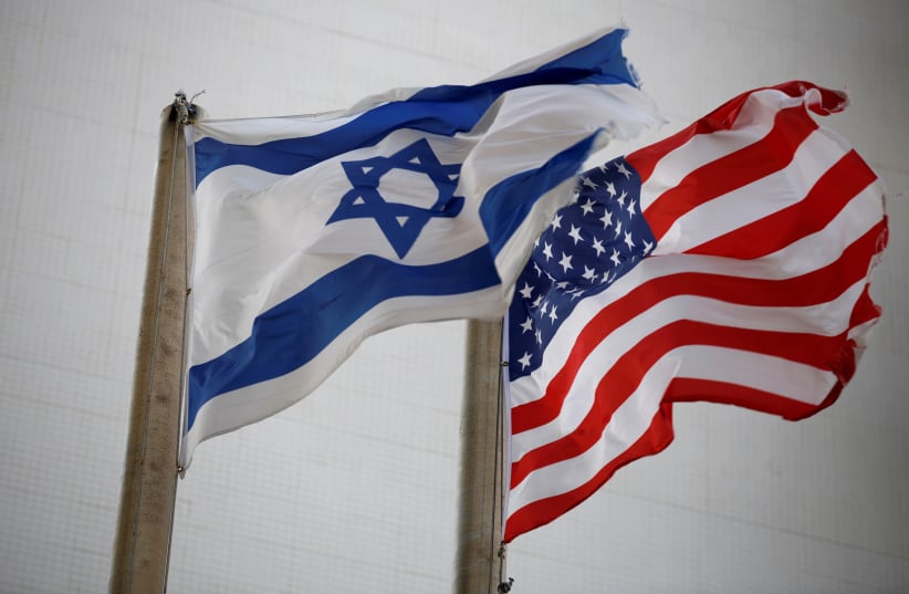 The American and the Israeli national flags can be seen outside the U.S Embassy in Tel Aviv (photo credit: AMIR COHEN/REUTERS)