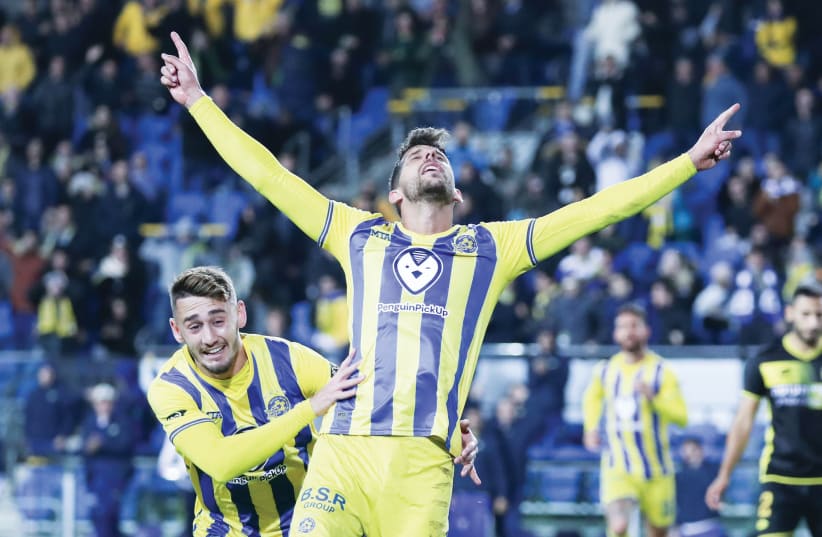 Maccabi Tel Aviv's Dor Micha (front) celebrates with teammate Omer Atzili after scoring the side's second goal in a 4-1 victory over Maccabi Netanya (photo credit: DANNY MAROM)