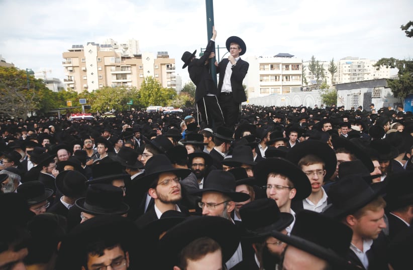 ULTRA-ORTHODOX Jews gather during a funeral ceremony in Bnei Brak. (photo credit: REUTERS/BAZ RATNER)