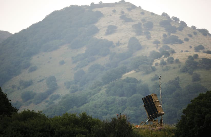 AN IRON DOME antimissile system is installed near the Israeli side of the border with Syria in the Golan Heights  (photo credit: AMIR COHEN/REUTERS)
