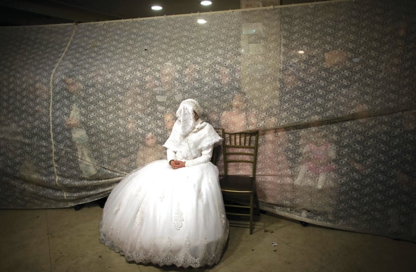 A JEWISH bride waits for her groom during a traditional wedding ceremony in Jerusalem (photo credit: RONEN ZVULUN/REUTERS)