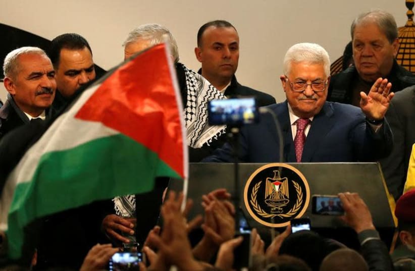 Palestinian Authority President Mahmoud Abbas gestures during a ceremony marking the 54th anniversary of Fatah's founding, in Ramallah, December 31, 2018 (photo credit: MOHAMAD TOROKMAN/REUTERS)