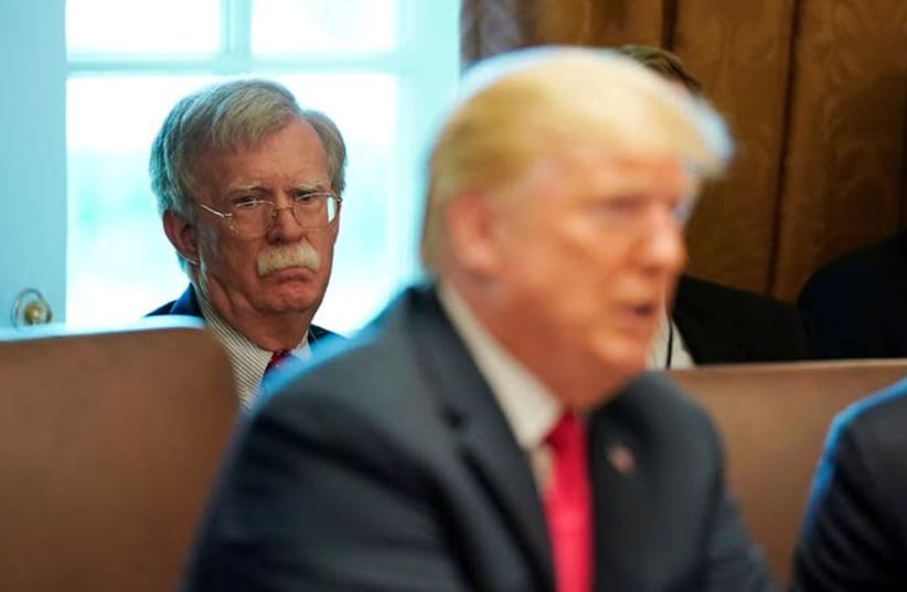 White House national Security Advisor John Bolton listens as U.S. President Donald Trump holds a cabinet meeting at the White House in Washington, U.S., August 16, 2018 (photo credit: KEVIN LAMARQUE/REUTERS)