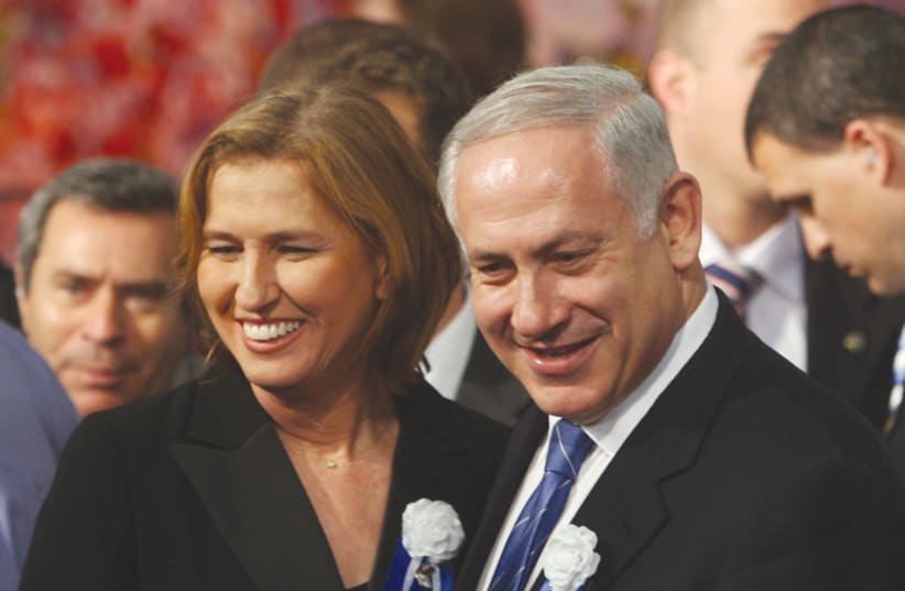 LIKUD PARTY leader Benjamin Netanyahu and Kadima Party head Tzipi Livni attend the swearing-in ceremony of the 18th Knesset in 2009 (photo credit: JIM HOLLANDER / POOL / REUTERS)