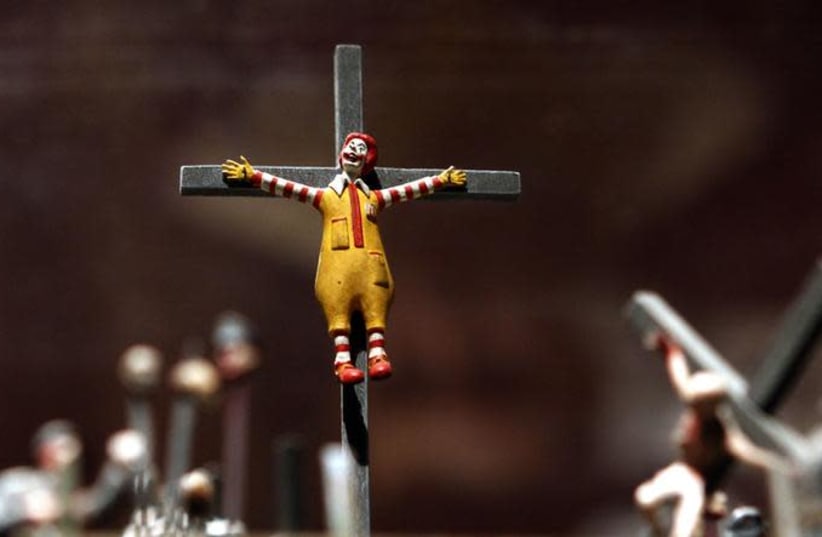 A figure of a crucified Ronald McDonald (photo credit: REUTERS/ALEXANDER DEMIANCHUK)