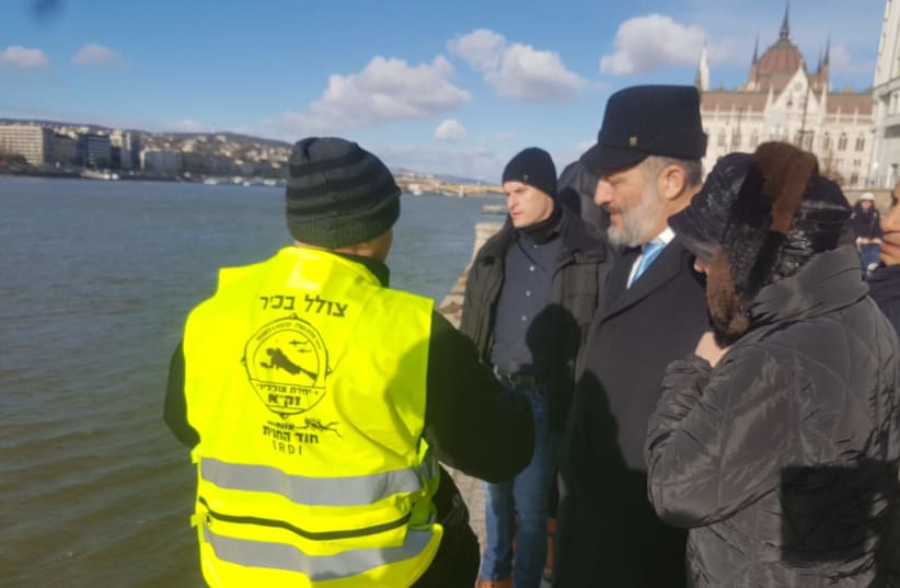 Deri, escorted by ZAKA divers, is standing at the banks of the Danube in Hungary (photo credit: ZAKA RESCUE AND RECOVERY ORGANIZATION)