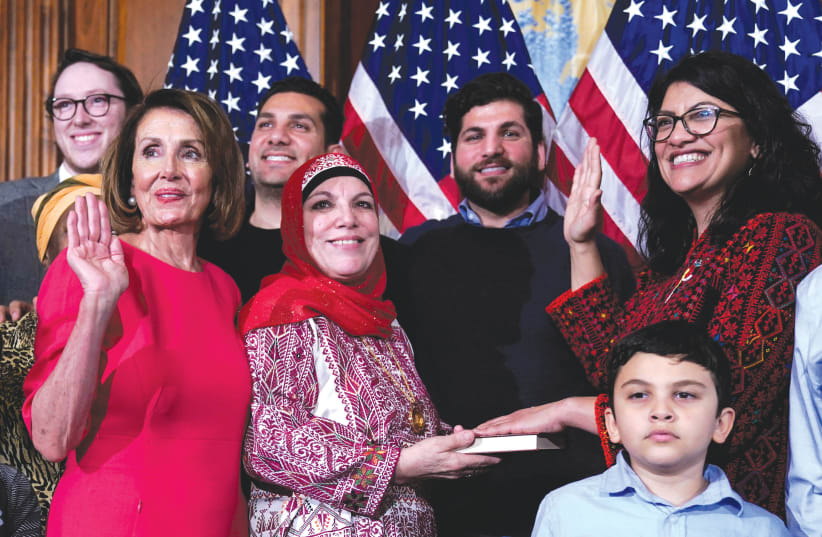 REP. RASHIDA Tlaib (D-Michigan, far right) poses with Speaker of the House Nancy Pelosi (D-California) for a ceremonial swearing-in picture on Capitol Hill on January 3 (photo credit: JOSHUA ROBERTS / REUTERS)