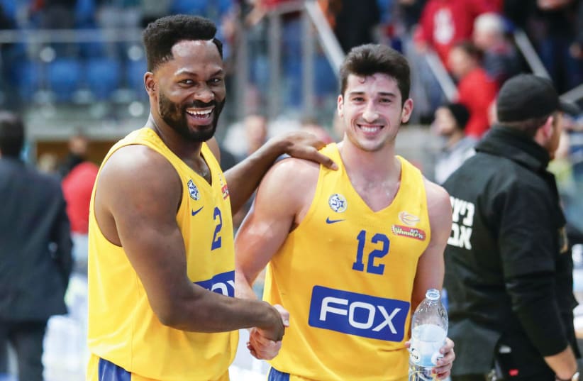 MACCABI TEL AVIV guards Jeremy Pargo (left) and John DiBartlomeo (right) are all smiles after the yellow-and-blue coasted to a 99-76 road victory over Hapoel Beersheba on Monday night in Basketball Super League action.  (photo credit: DANNY MARON)