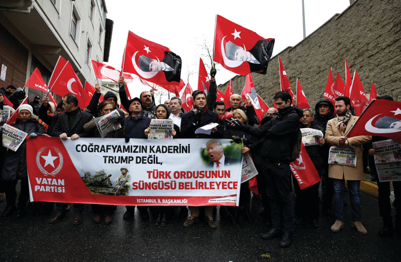 MEMBERS OF Vatan (Patriotic) Party wave flags of Turkey and of their party during a protest against US President Donald Trump near the US Consulate in Istanbul yesterday. The banner reads ‘The destiny of our geography will not be determined by Trump but by the bayonet of the Turkish army.’ (photo credit: HUSEYIN ALDEMIR/REUTERS)