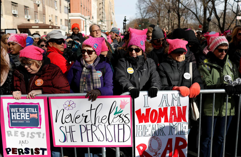 People line Central Park West as they participate in the Women's March in Manhattan, New York City, New York, U.S., January 20, 2018 (photo credit: ANDREW KELLY / REUTERS)