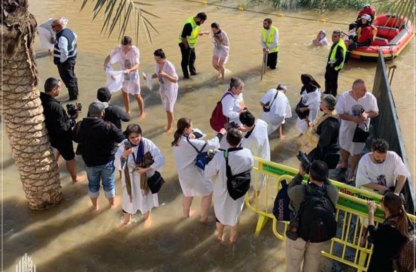 Pilgrims enter the Jordan River during the celebration of the Epiphany, Friday January 18 2019 (photo credit: Courtesy)