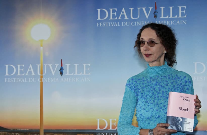 Writer Joyce Carol Oates poses with her book "Blonde" during a photocall after she won the Literary Award at the 36th American film festival in Deauville September 9, 2010.  (photo credit: REUTERS/VINCENT KESSLER)