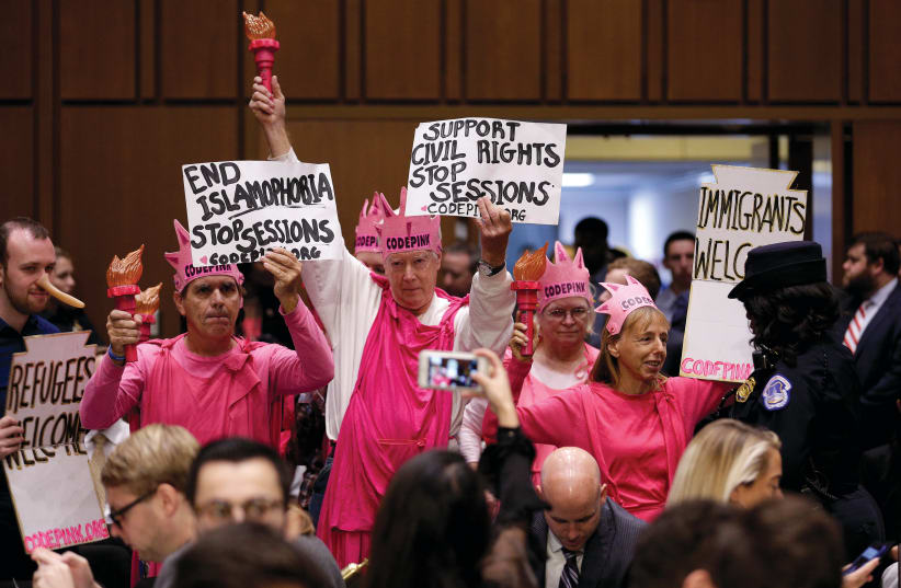 MEMBERS OF Code Pink protest before US Attorney-General Jeff Sessions testifies before a Senate Judiciary oversight hearing on Capitol Hill in 2017 (photo credit: JOSHUA ROBERTS / REUTERS)