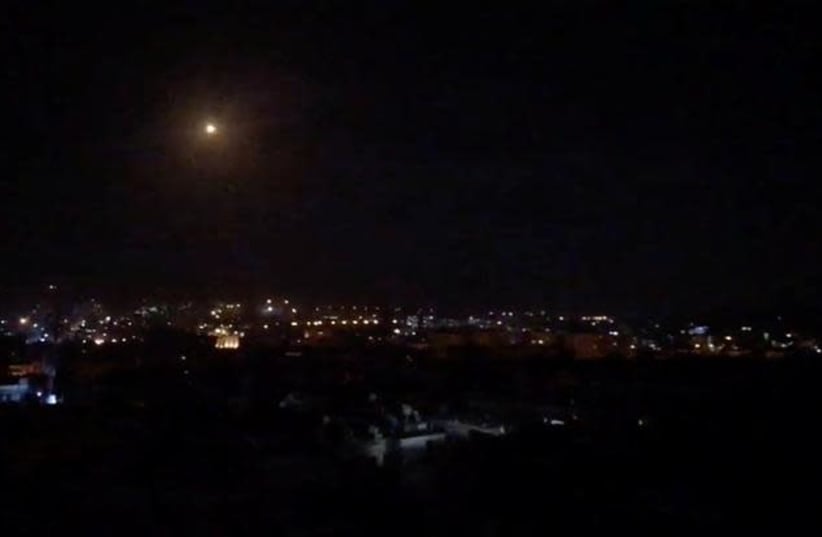 What is believed to be guided missiles are seen in the sky during what is reported to be an attack in Damascus, Syria, January 21, 2019, in this still image taken from a video obtained from social media (photo credit: FACEBOOK DIARY OF A MORTAR SHELL IN DAMASCUS/YOUMIYAT QADIFAT HAWUN FI DAMASHQ/VIA REUTERS)