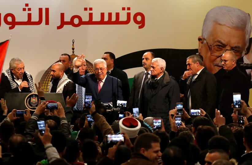 Palestinian President Mahmoud Abbas gestures during a ceremony marking the 54th anniversary of Fatah's founding, in Ramallah, December 31, 2018 (photo credit: MOHAMAD TOROKMAN/REUTERS)