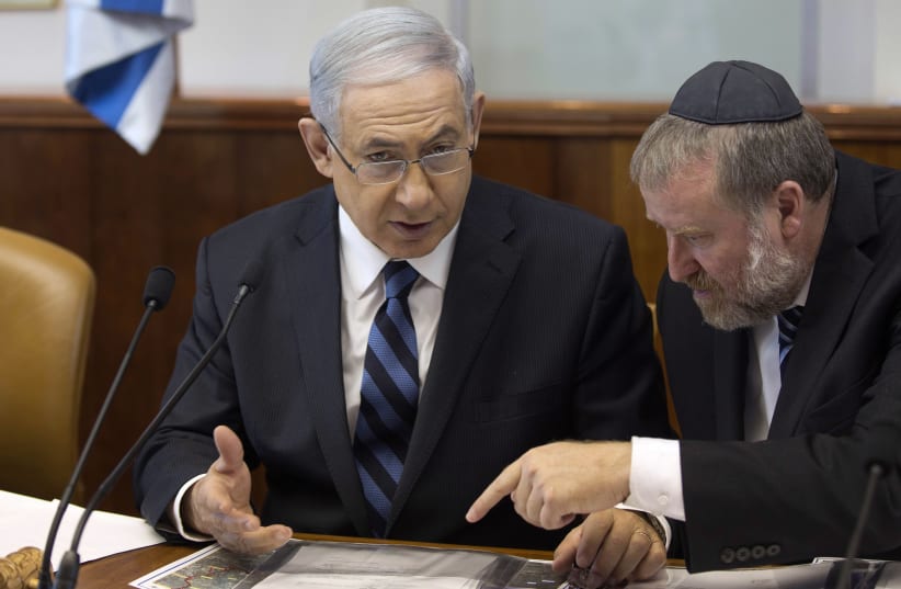 Israel's Prime Minister Benjamin Netanyahu speaks with Cabinet Secretary Avichai Mandelblit (R) during the weekly cabinet meeting in Jerusalem (photo credit: MENAHEM KAHANA / REUTERS)