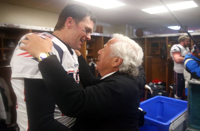 New England Patriots quarterback Tom Brady (12) greets owner Robert Kraft in the locker room as they celebrate their win over the Kansas City Chiefs during overtime in the AFC Championship game at Arrowhead Stadium (photo credit: MARK REBILAS-USA TODAY SPORTS)