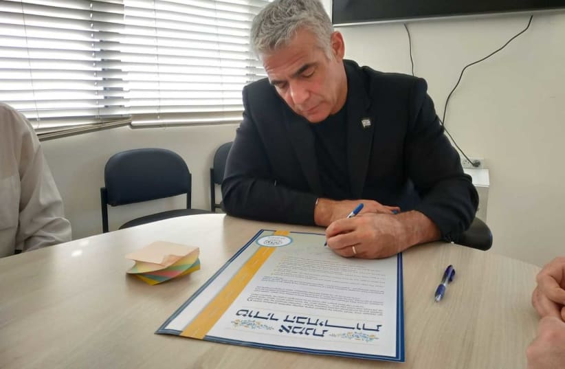 Yesh Atid leader Yair Lapid signs Tzohar document calling for elections in pure spirit  (photo credit: Courtesy)