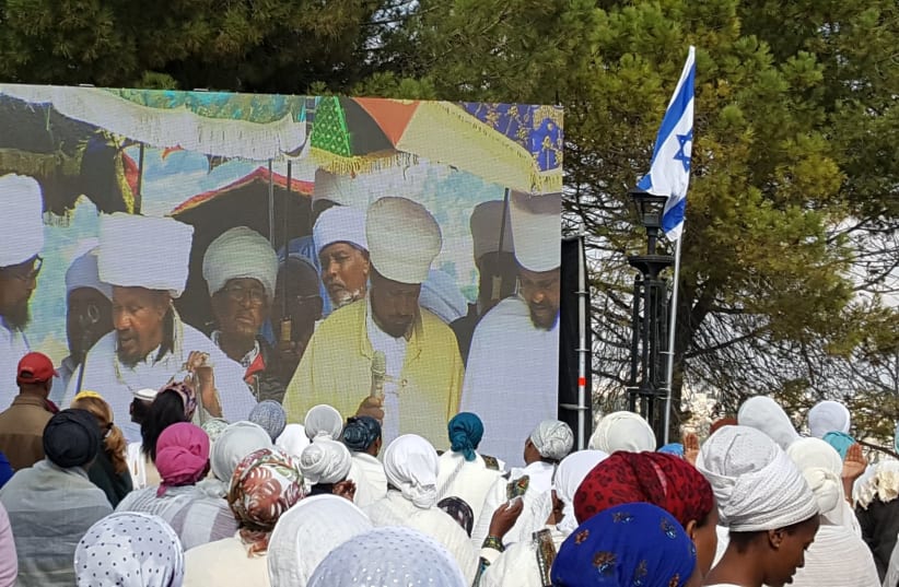 Leaders of the Jewish-Ethiopian community displayed on a large screen as they lead worshipers in the Sigd holiday prayers in Jerusalem, November 17, 2018. (photo credit: BEN BRESKY)