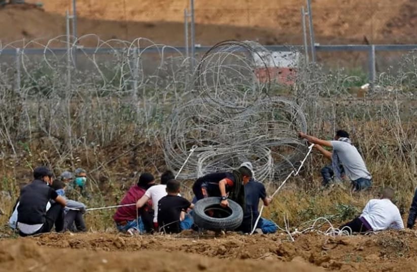 Palestinian demonstrators disturb the Gaza-Israel border fence during the 44th weekly protest called the "Great March Of Return" (photo credit: Courtesy)
