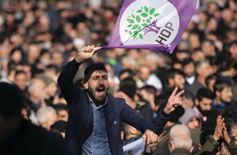 A SUPPORTER of the pro-Kurdish Peoples’ Democratic Party protests earlier this month in Diyarbakir, Turkey.  (photo credit: SERTAC KAYAR / REUTERS)