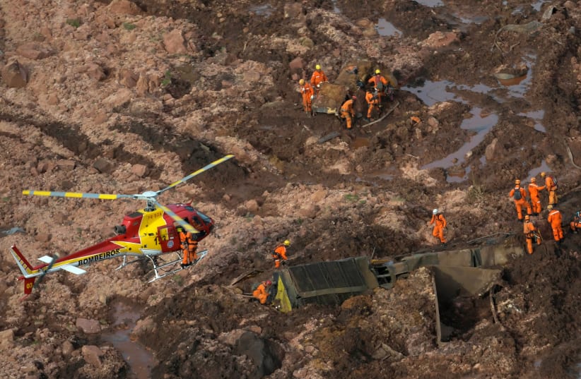 Rescue crew work in a dam that burst in Brazil (photo credit: Courtesy)