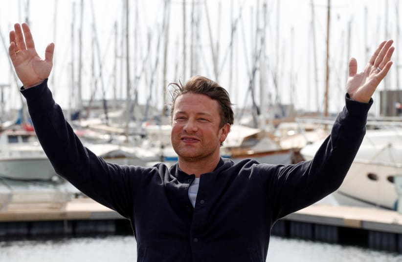 Chef Jamie Oliver poses during a photocall at the annual MIPCOM television program market in Cannes, France, October 15, 2018. (photo credit: ERIC GAILLARD/REUTERS)