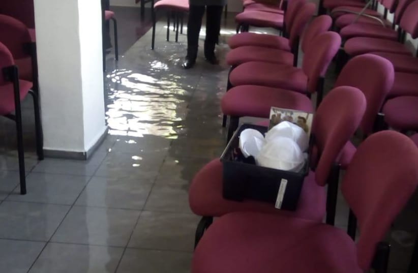The flooded synagogue in Netanya after vandals inserted a hose through the window (photo credit: Courtesy)