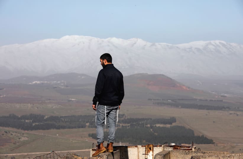 A MAN stands at Mount Bental, an observation post on the Golan Heights that overlooks the Syrian side of the Quneitra crossing, on January 21. (photo credit: REUTERS)