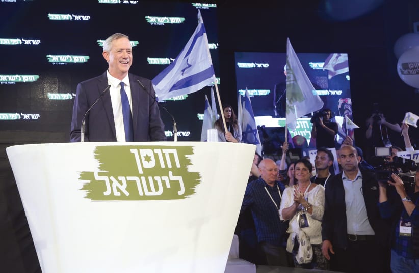 BENNY GANTZ listens to the cheers of the crowd gathered Tuesday night in Tel Aviv to hear his inaugural address.  (photo credit: MARC ISRAEL SELLEM)