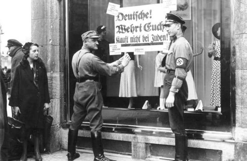 At the windows of Jewish shops, posters are issued by National Socialists with the request "Germans, resist, do not buy from Jews" April 1933 (photo credit: GEORG PAHL / GERMAN FEDERAL ARCHIVES / WIKIMEDIA COMMONS)