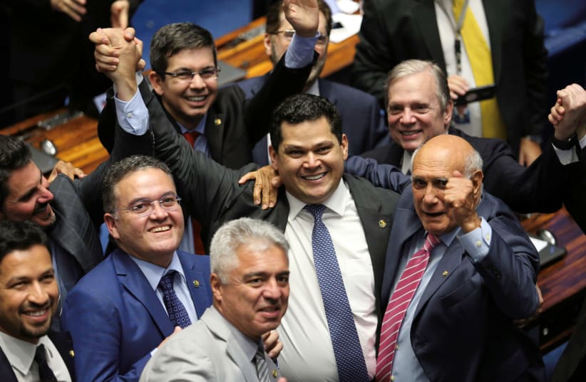 Davi Alcolumbre, from the Democratas party is congratulated by his colleagues after being elected for presidency of Brazilian senate in Brasilia, Brazil February 2, 2019. (photo credit: RODRIGUES POZZEBOM/AGENCIA BRASIL/HANDOUT VIA REUTERS ATTENTION EDITORS)