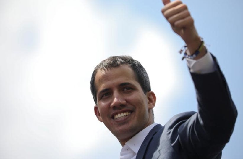 Juan Guaido gives the thumps up to supporters, as he attends a rally against Venezuelan President Nicolas Maduro's government in Caracas, Venezuela February 2, 2019 (photo credit: REUTERS/ANDRES MARTINEZ CASARES)