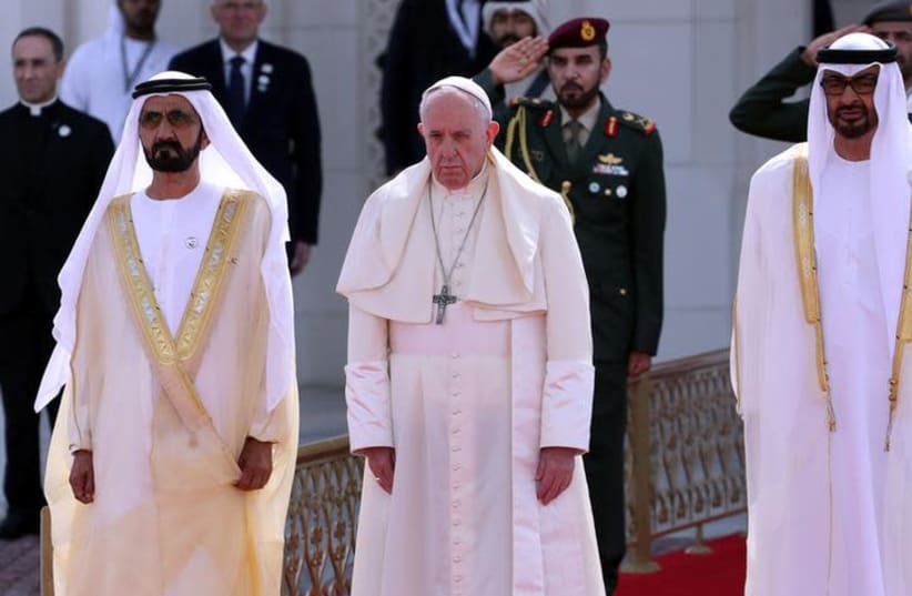 Pope Francis stands next to Vice-President of the United Arab Emirates and ruler of Dubai Sheikh Mohammed bin Rashid al-Maktoum, and Abu Dhabi's Crown Prince Mohammed bin Zayed Al-Nahyan during a welcome ceremony at the Presidential Palace in Abu Dhabi, United Arab Emirates, February 4, 2019 (photo credit: REUTERS/TONY GENTILE)