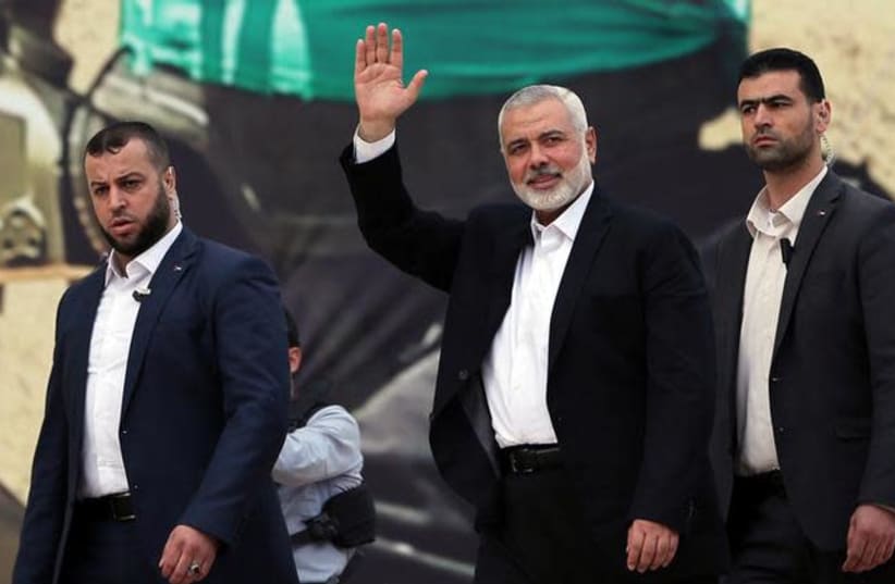 Hamas Chief Ismail Haniyeh gestures during a rally marking the 31st anniversary of Hamas' founding (photo credit: REUTERS/IBRAHEEM ABU MUSTAFA)