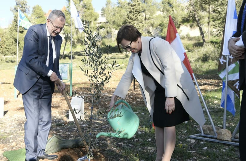 President of Austria, H.E. Dr. Alexander Van Der Bellen and his wife H.E. Ms. Doris Schmidauer planting a tree at the Grove of Nations in Jerusalem (photo credit: AVI HAYUN/KKL-JNF)