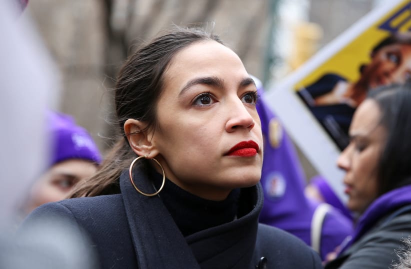 Rep. Alexandria Ocasio-Cortez (D-NY) looks on during a march organised by the Women's March Alliance in the Manhattan borough of New York City, U.S., January 19, 2019 (photo credit: CAITLIN OCHS/REUTERS)