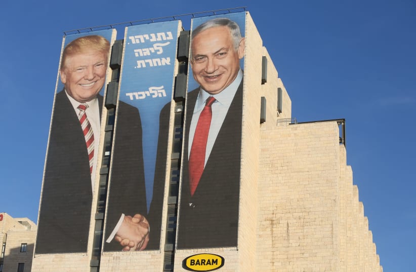 Elections poster showing Prime Minister Benjamin Netanyahu shaking hands with US President Donald Trump (photo credit: MARC ISRAEL SELLEM)