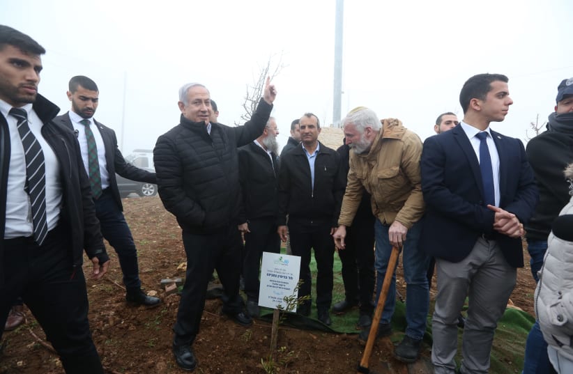 Prime Minister Benjamin Netanyahu plants a tree in the Gush Etzion region of the West Bank, January 28th, 2019, (photo credit: MARC ISRAEL SELLEM/THE JERUSALEM POST)