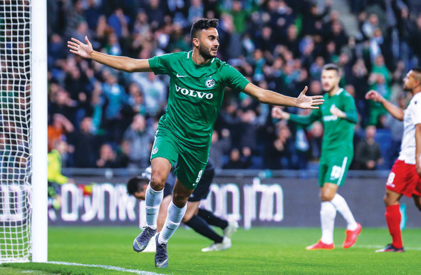 MACCABI HAIFA captain Muhamad Awad celebrates after scoring the first of his two goal in the Greens’ dramatic 3-2 victory over Hapoel Tel Aviv in Israel Premier League action on Monday night. (photo credit: MAOR ELKASLASI)