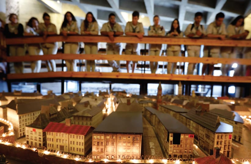 Israeli youth look at a model of the Warsaw Ghetto displayed at the ‘From Holocaust to Revival’ exhibition at Kibbutz Yad Mordechai (photo credit: AMIR COHEN/REUTERS)
