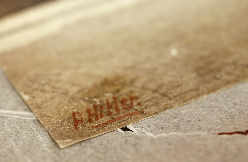 The signature of former German dictator Adolf Hitler is seen on a painting of the old registry office in Munich, at Weidler auction house in Nuremberg. (photo credit: KAI PFAFFENBACH/REUTERS)