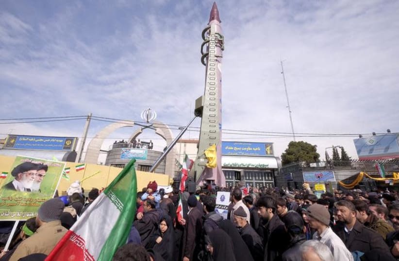 Iranian-made Emad missile is displayed during a ceremony (photo credit: REUTERS/RAHEB HOMAVANDI)