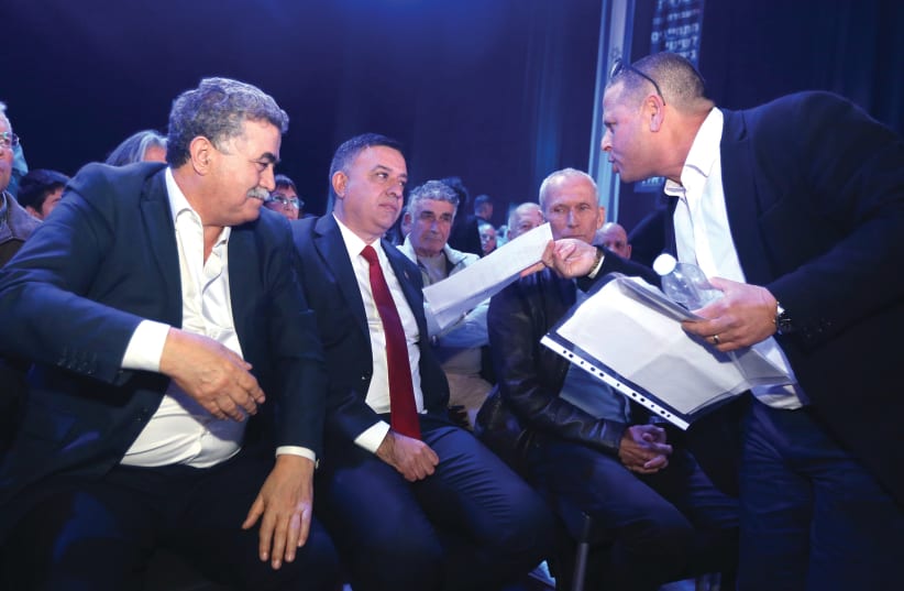 LABOR LEADER Avi Gabbay is harangued by MK Eitan Cabel (right) as MK Amir Peretz looks on during a meeting of the party last month (photo credit: MARC ISRAEL SELLEM/THE JERUSALEM POST)