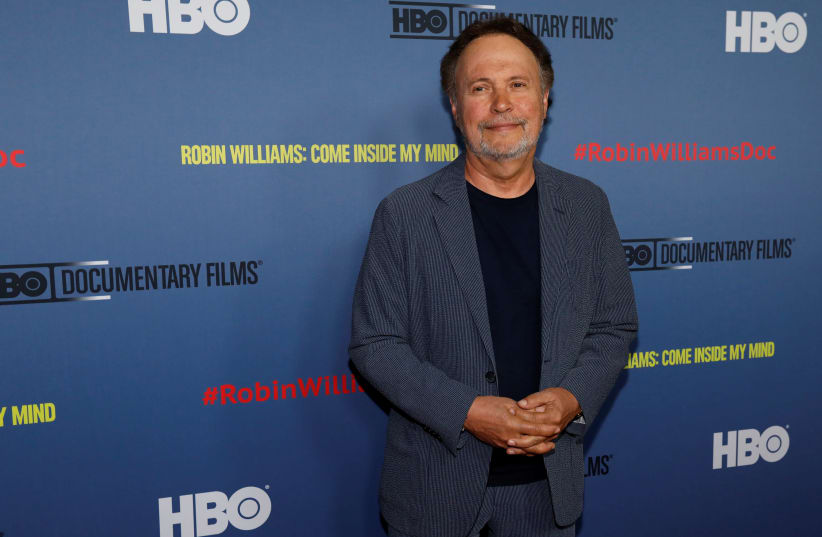Actor Billy Crystal poses at the premiere for the documentary "Robin Williams: Come Inside My Mind" in California, 2018. (photo credit: REUTERS/MARIO ANZUONI)