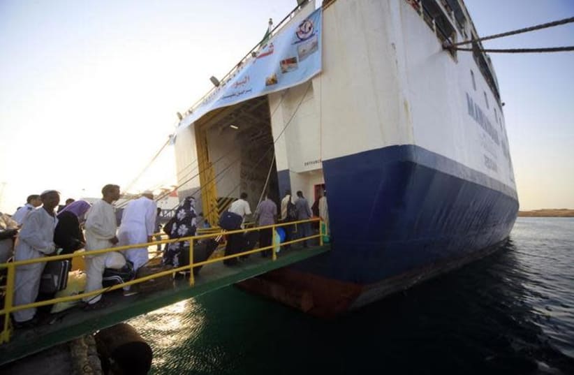 Pilgrims board a ferry at Suakin port in the Red Sea state (photo credit: REUTERS/MOHAMED NURELDIN ABDALLAH)