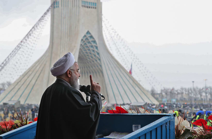 A handout picture provided by the Iranian presidency on February 11, 2019 shows President Hassan Rouhani addressing crowds during a ceremony celebrating the 40th anniversary of Islamic Revolution in the capital Tehran's Azadi (Freedom) square (photo credit: HO / IRANIAN PRESIDENCY / AFP)