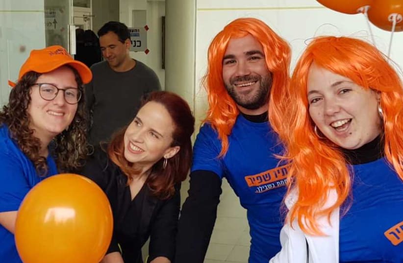 Labor MK Stav Shaffir (C) with a group of supporters at a polling location for the party's primary elections, February 11th, 2019 (photo credit: Courtesy)