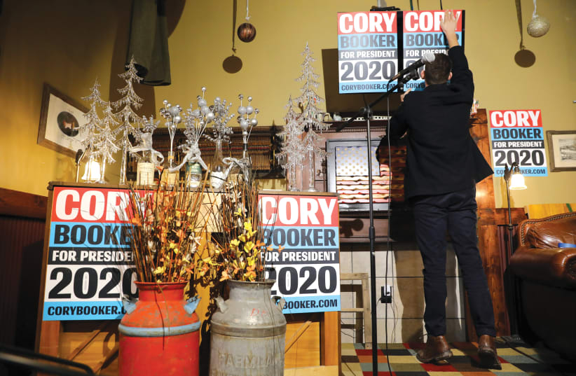 A CORY Booker supporter puts up a placard.  (photo credit: REUTERS)