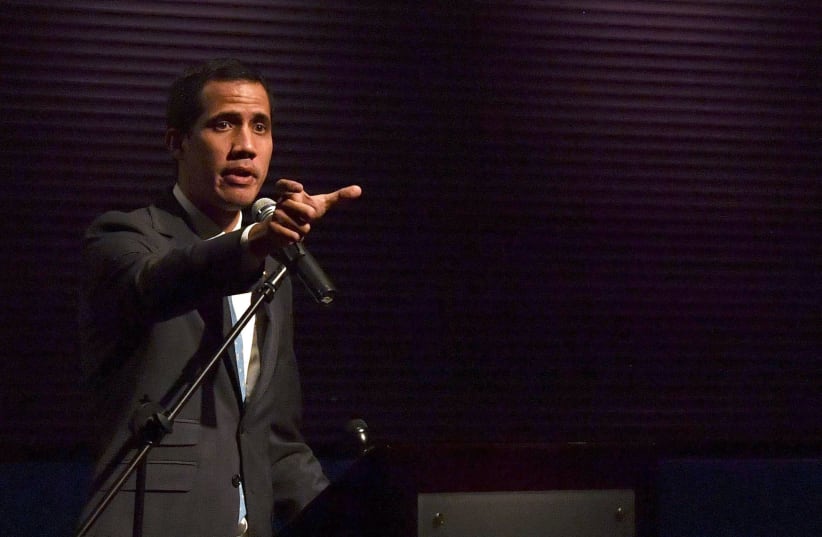 Venezuela's National Assembly head and self-proclaimed acting president Juan Guaido gestures while speaking to students at the Metropolitan University in Caracas, on February 11, 2019 (photo credit: YURI CORTEZ/AFP)